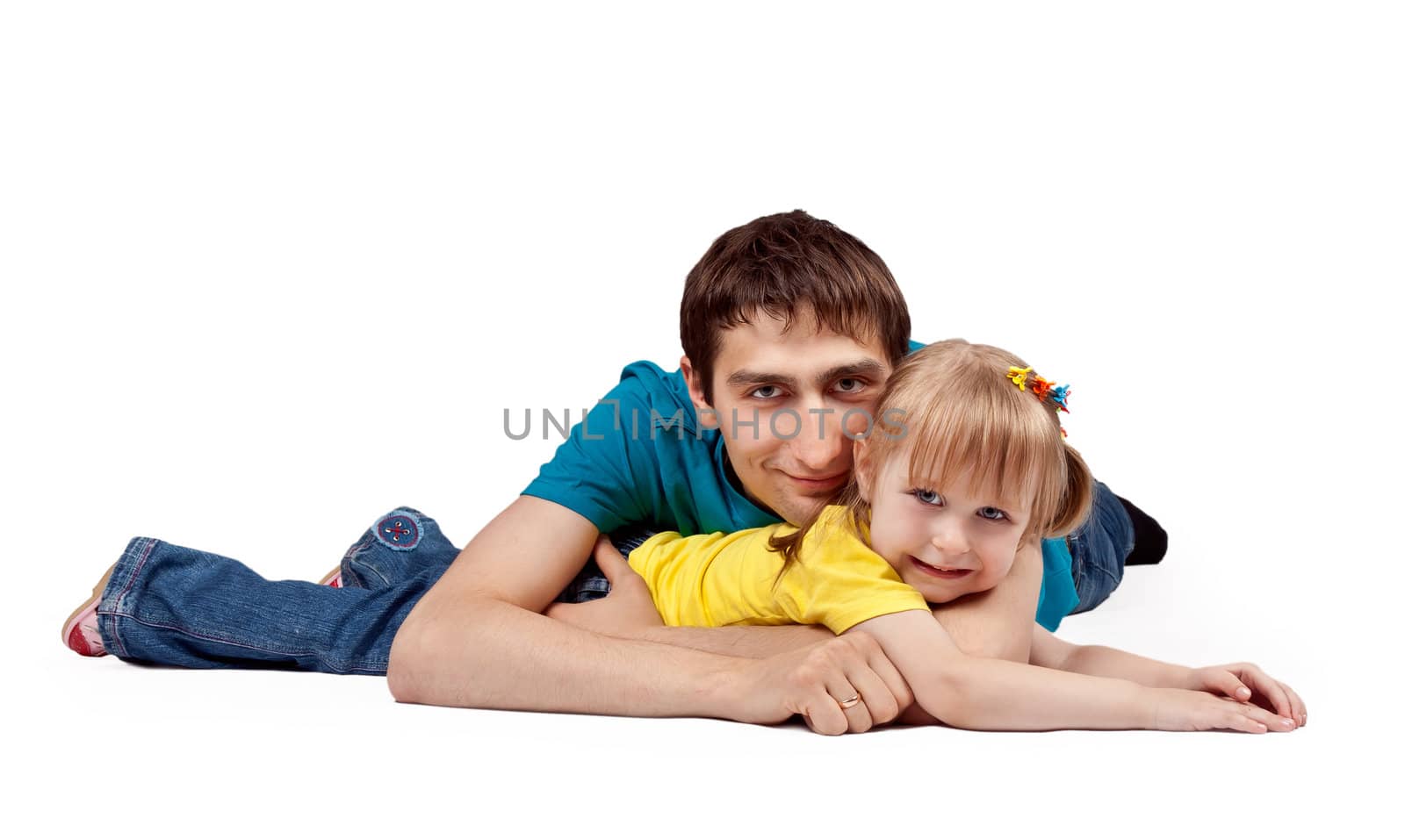 dad and little daughter lying on the floor in the studio on a white background