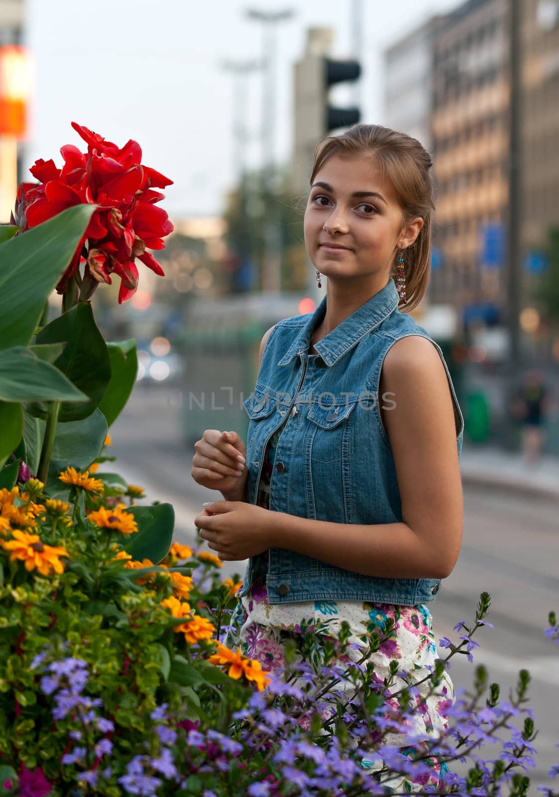 portrait of a girl in a denim vest with flowers