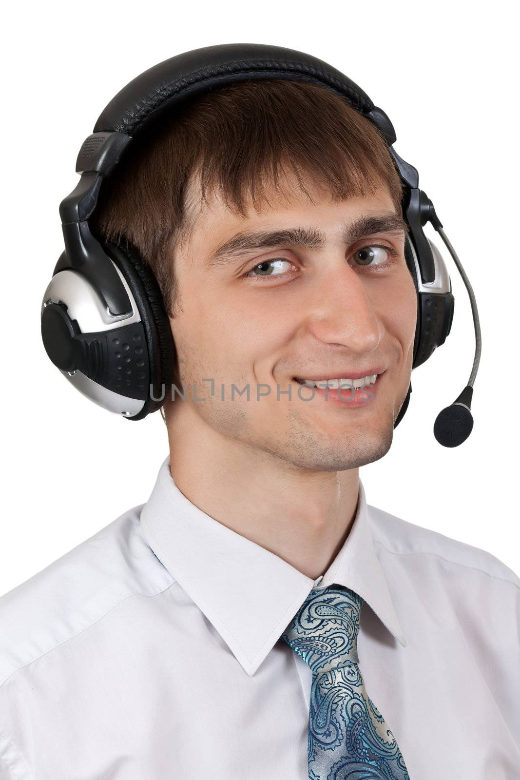 businessman in shirt and tie in the headphones with a microphone on a white background