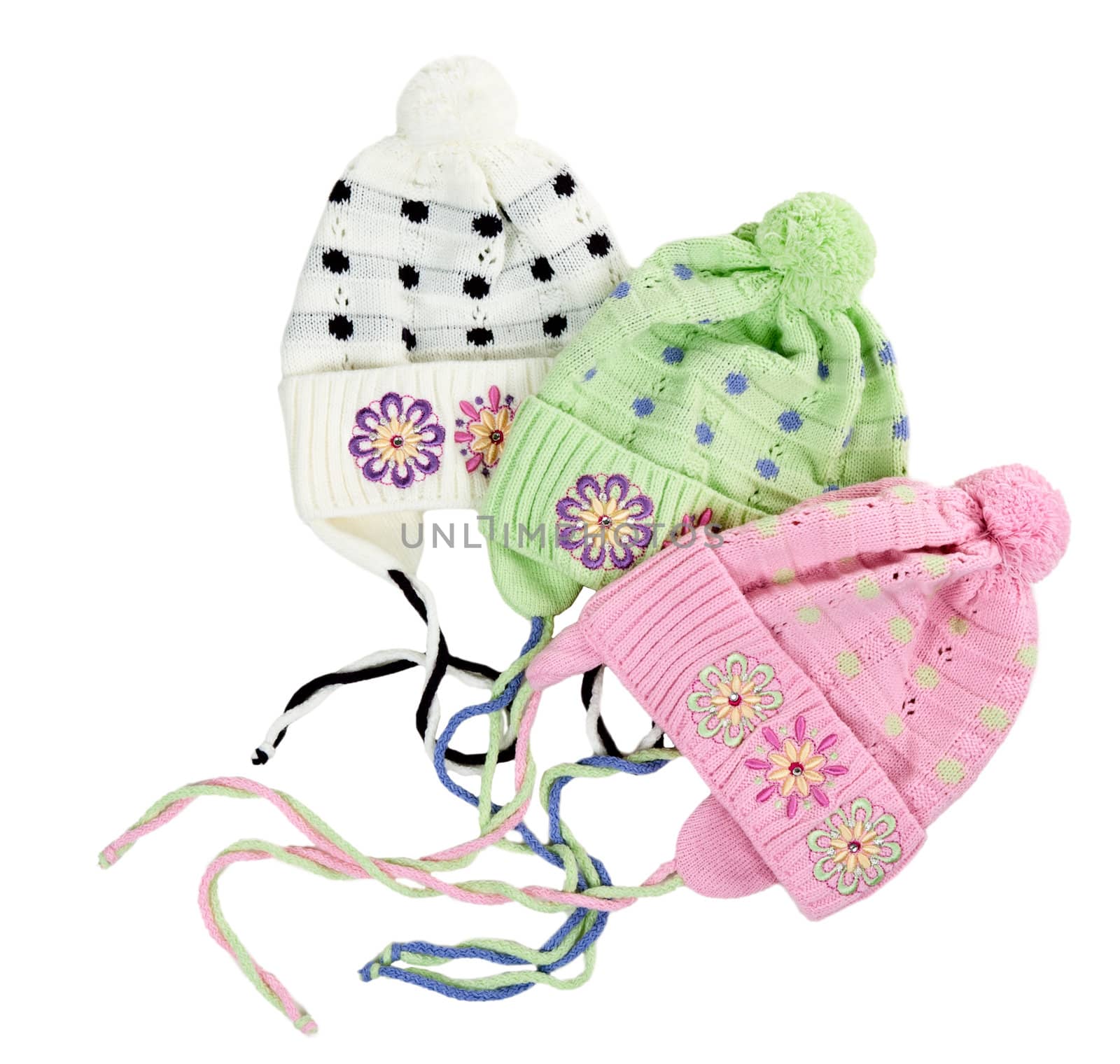 three colored children's knitted hat with a flower pattern on a white background