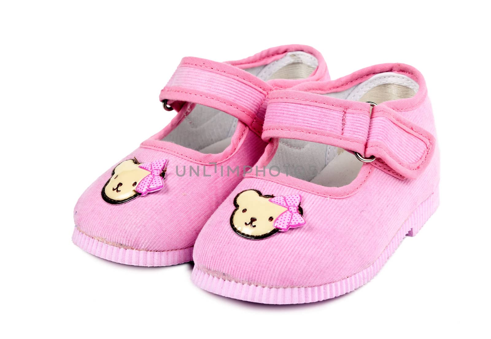 a pair of baby pink shoes isolated on white background