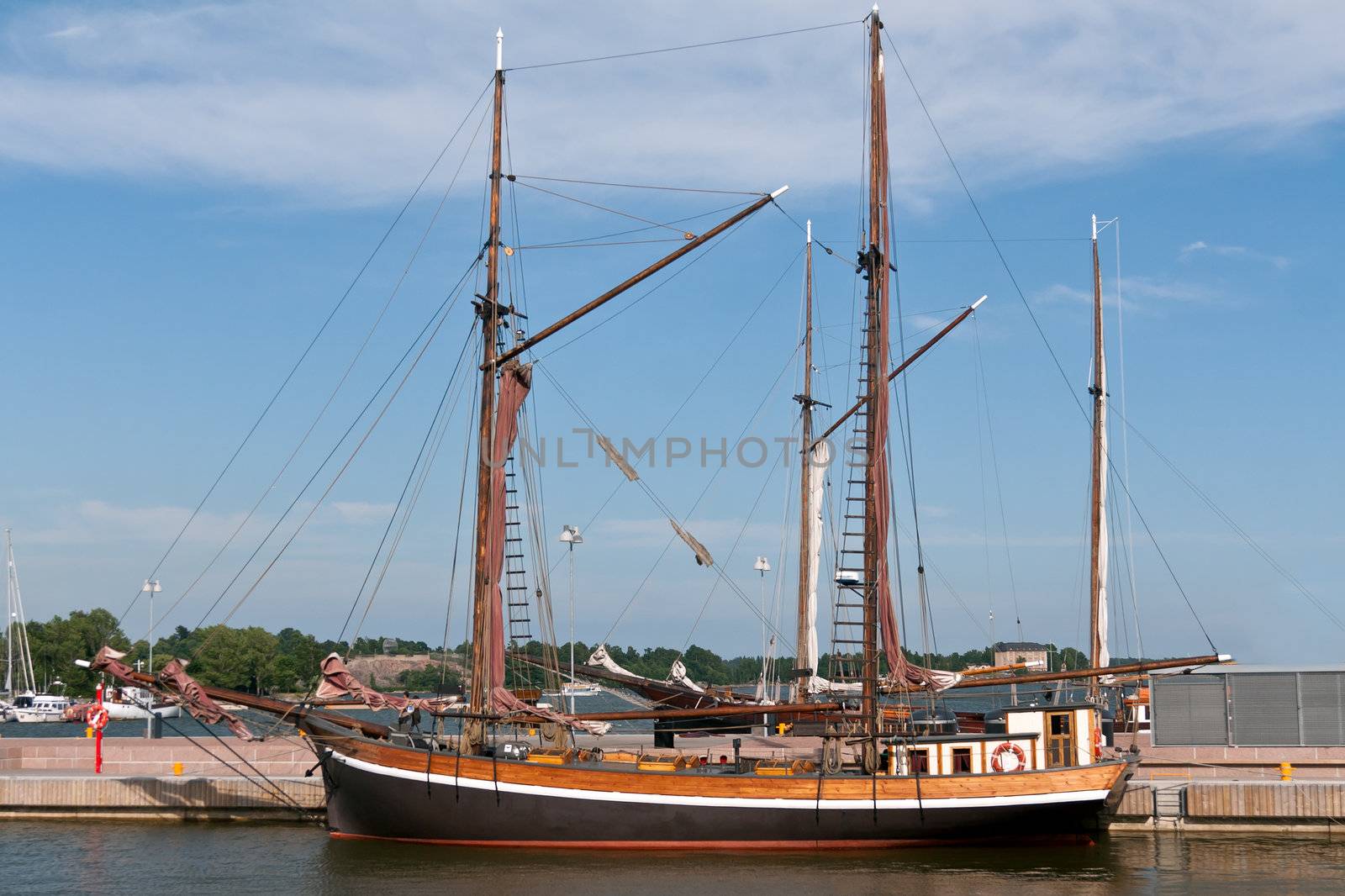 wooden sailing vessel in the port with a flat sail