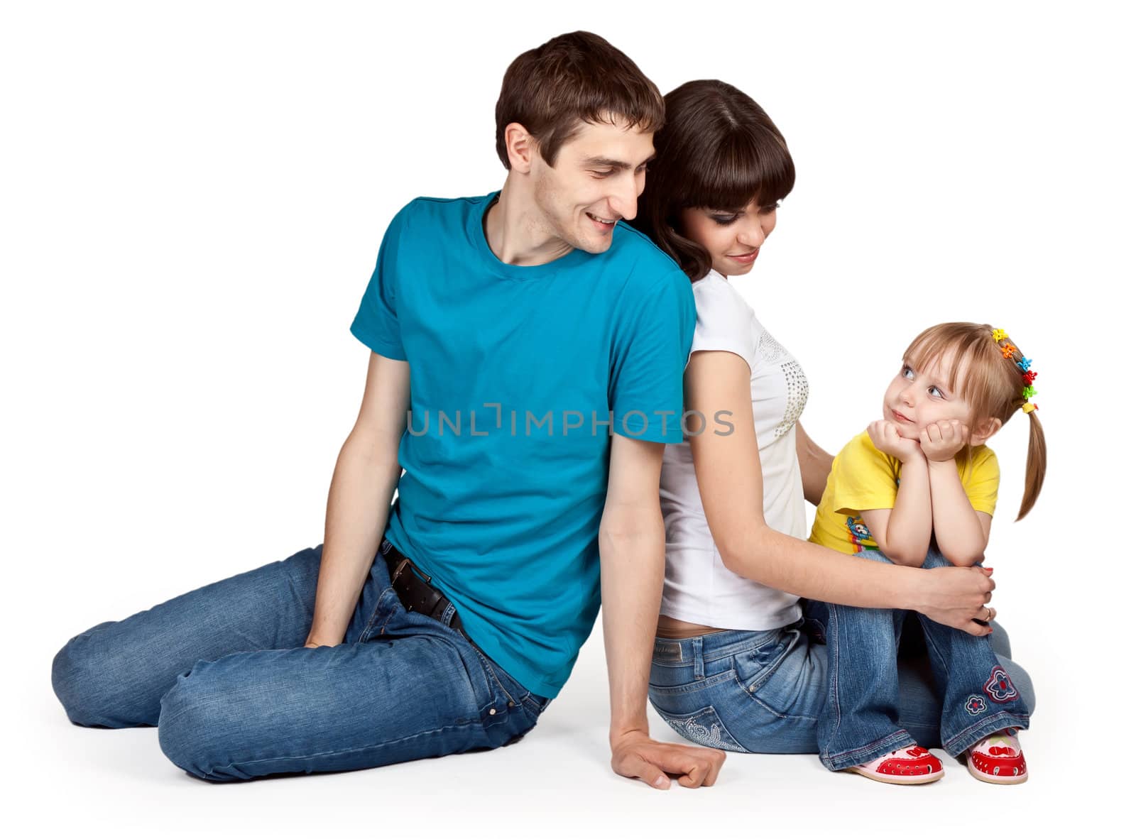 father, mother and young daughter in jeans at the studio on a white background