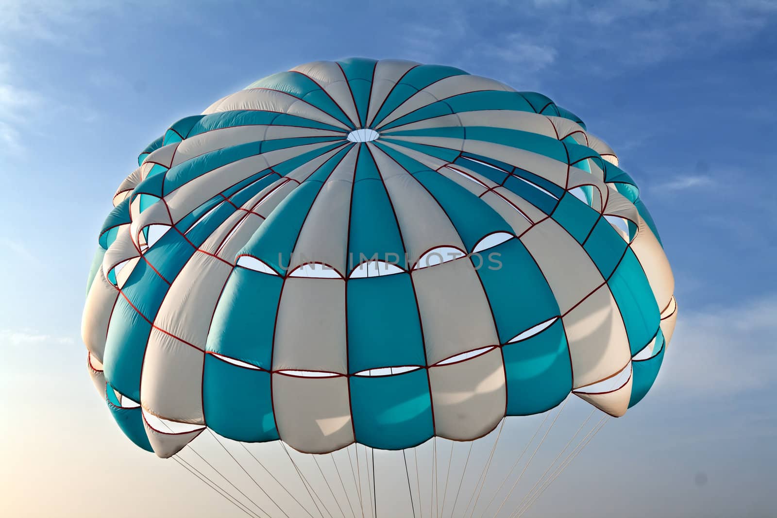 striped parachute in the sky with clouds