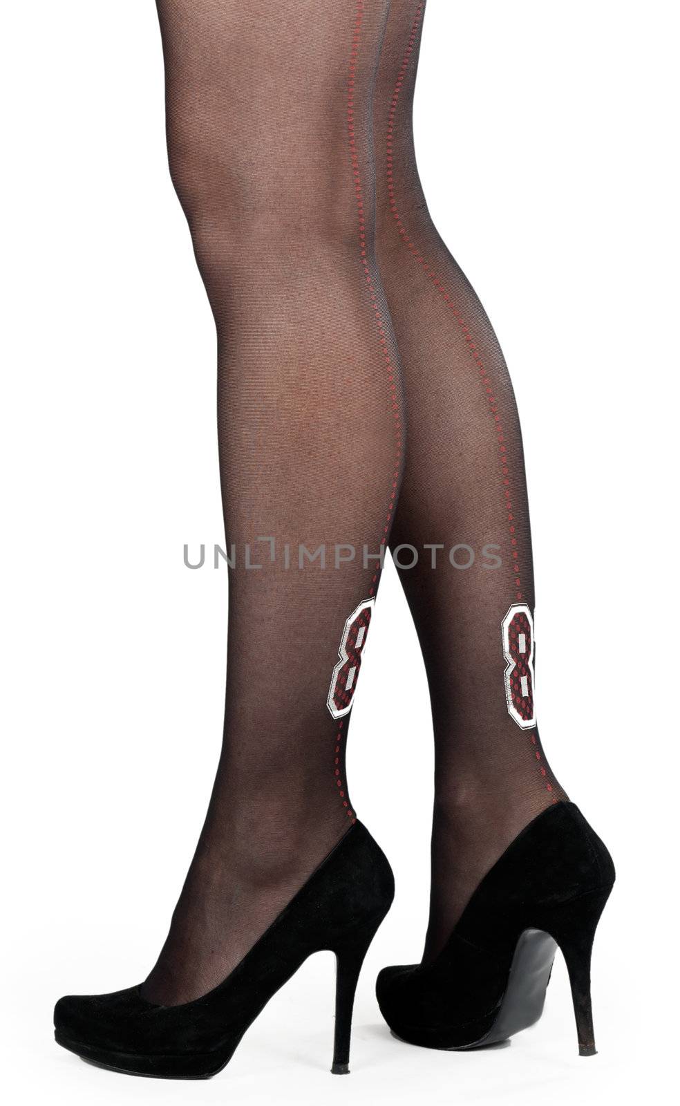 shapely female legs in pantyhose and shoes with heels in the studio on a white background