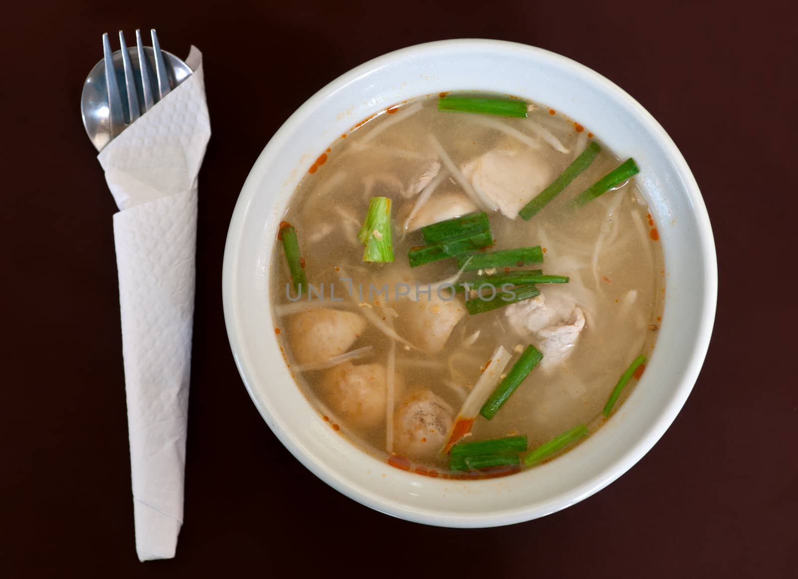 Thai soup dish with meat in brown cloth