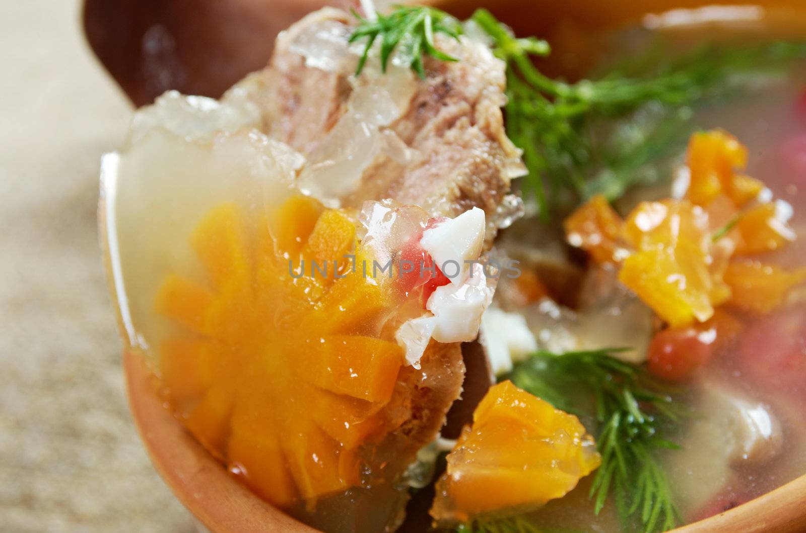 Aspic from meat decorated with egg, carrot,