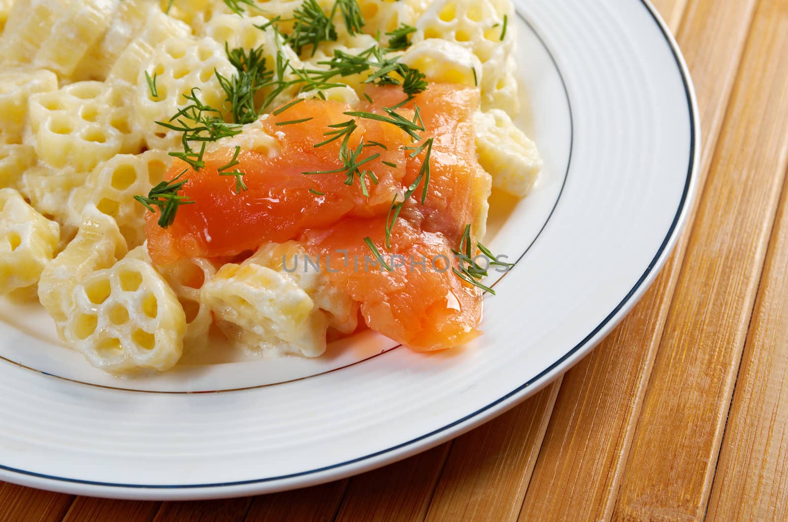 ruote pasta with cream sauce and salmon.closeup