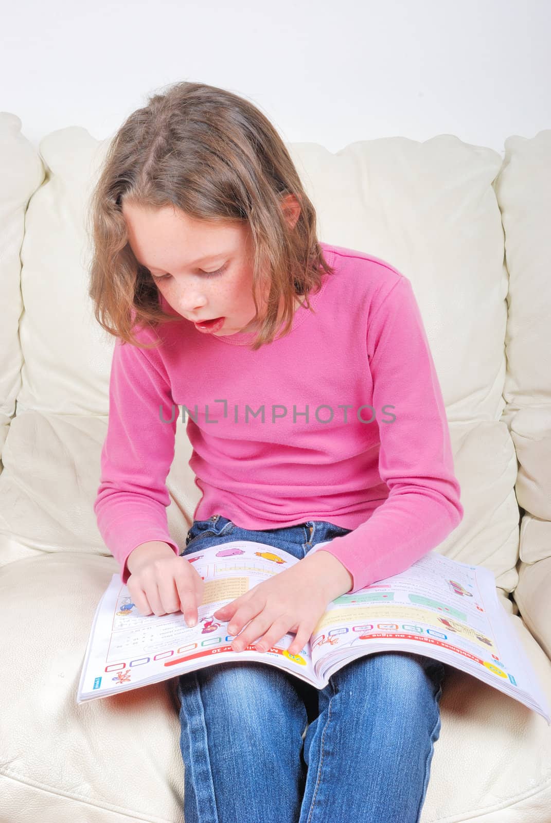 Girl student on the couch with a notebook