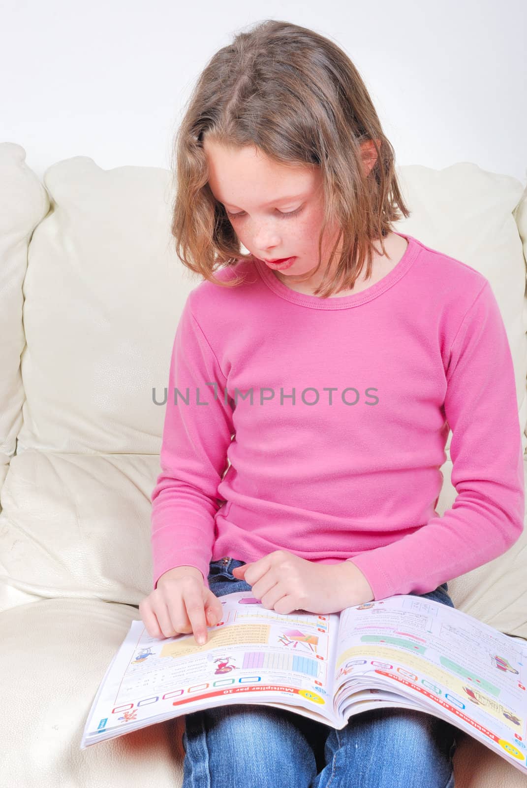 Girl student on the couch with a notebook