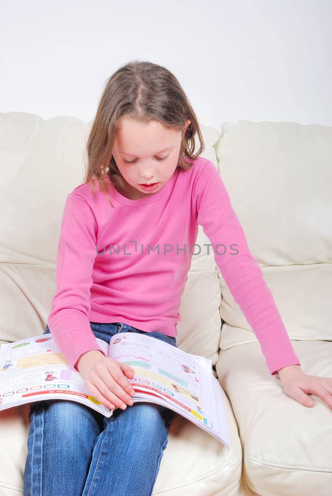 Girl student on the couch with a notebook