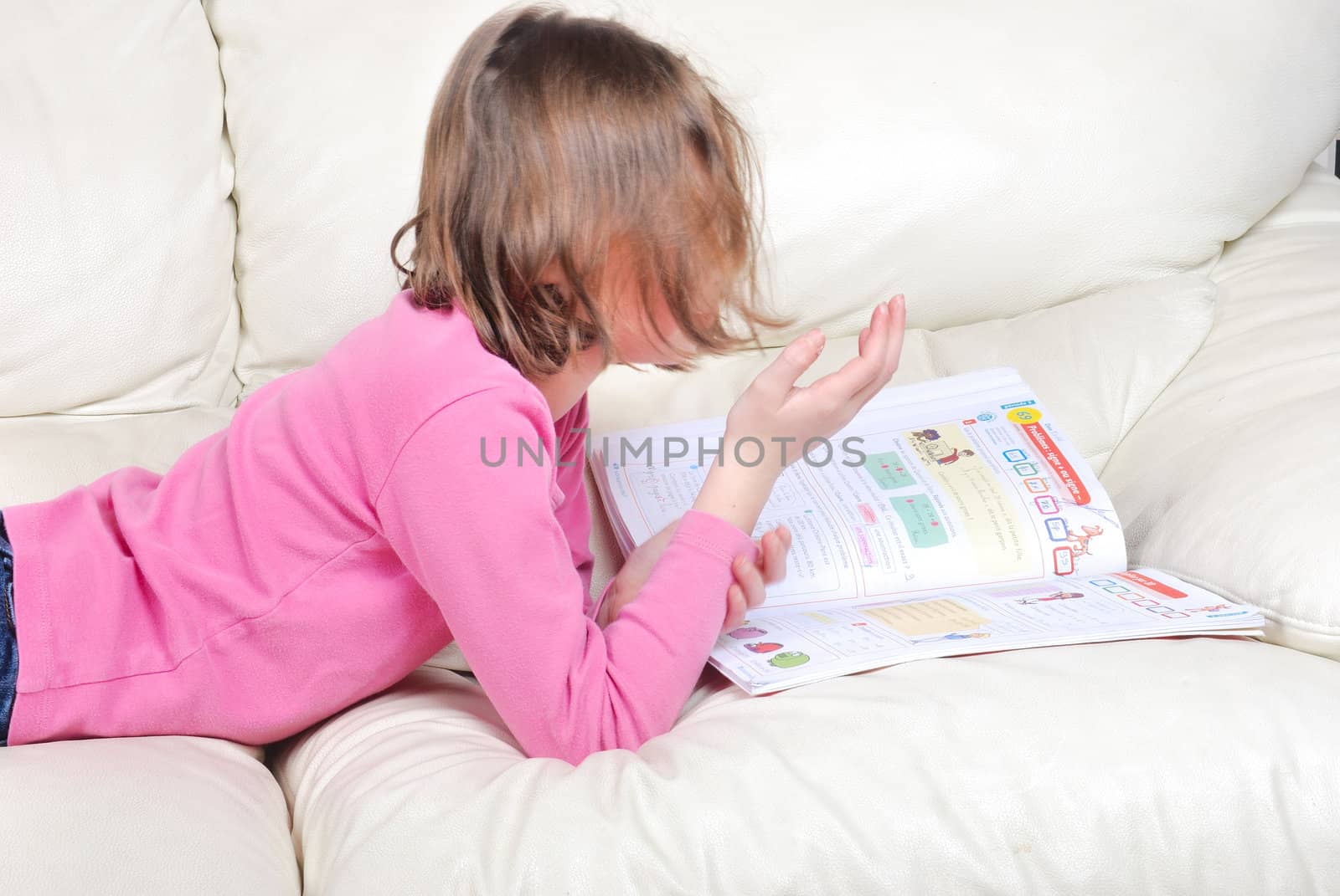 Girl student on the couch with a notebook