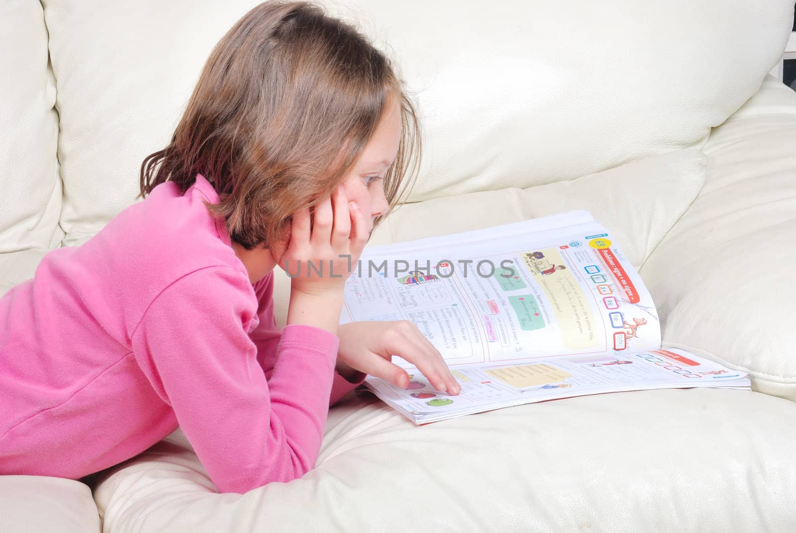 Girl student on the couch with a notebook