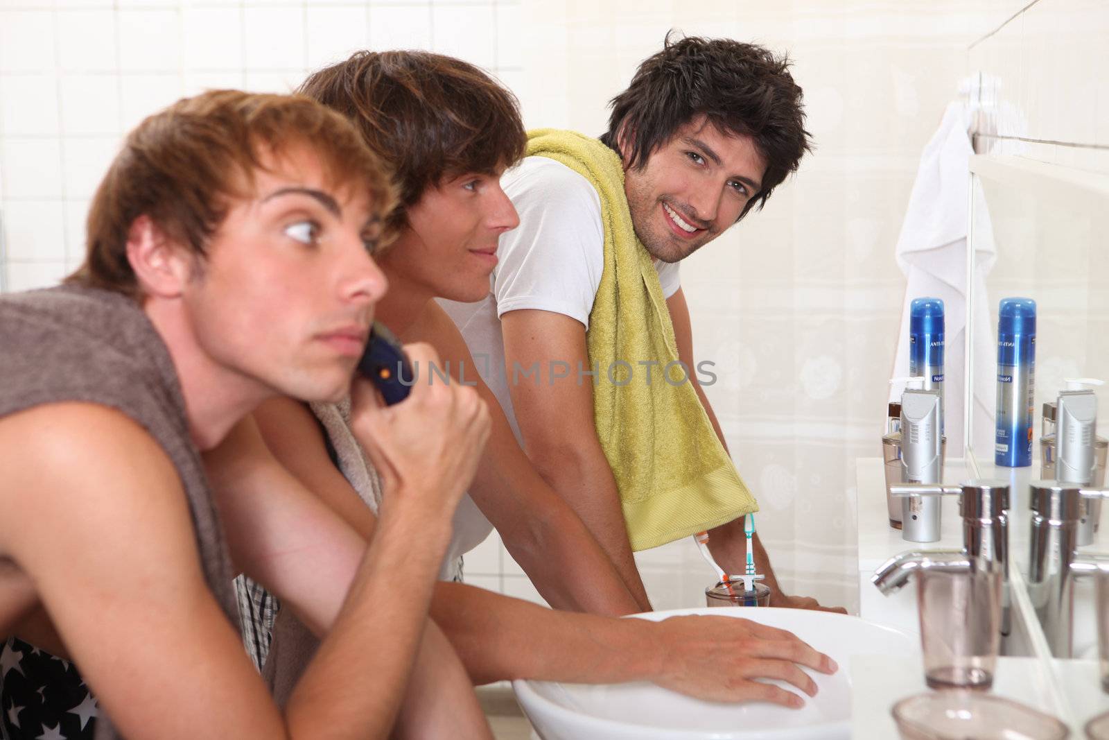 Three young men in bathroom by phovoir