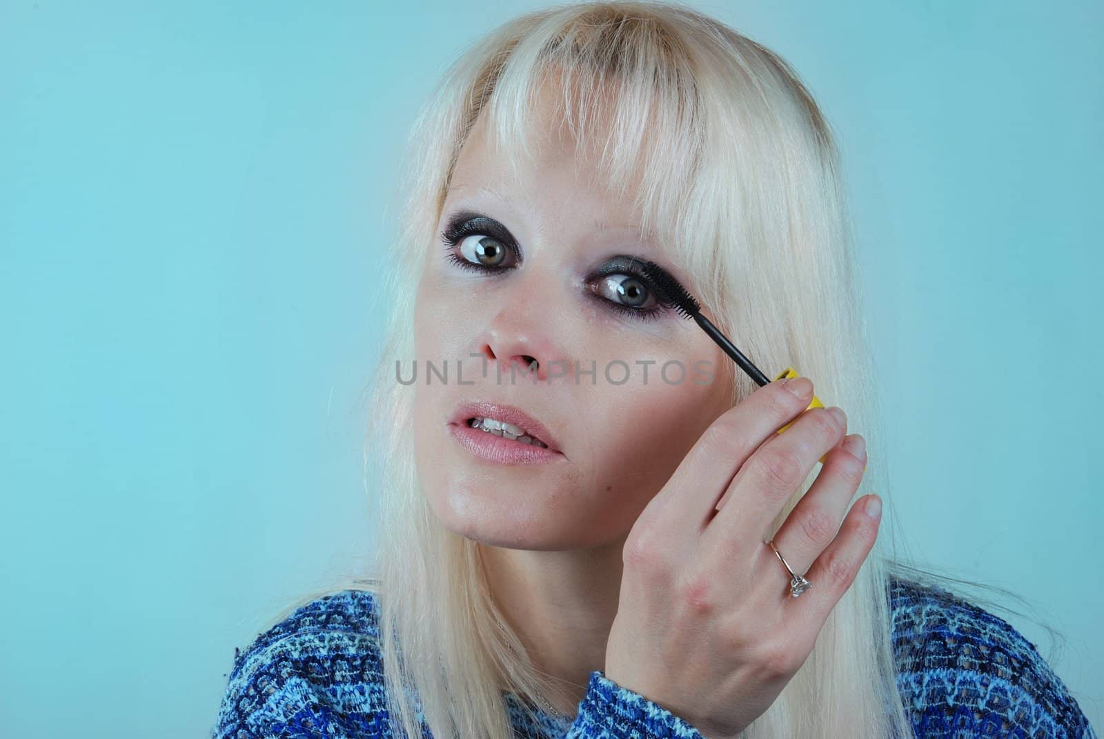 Woman applying makeup on her face by BZH22