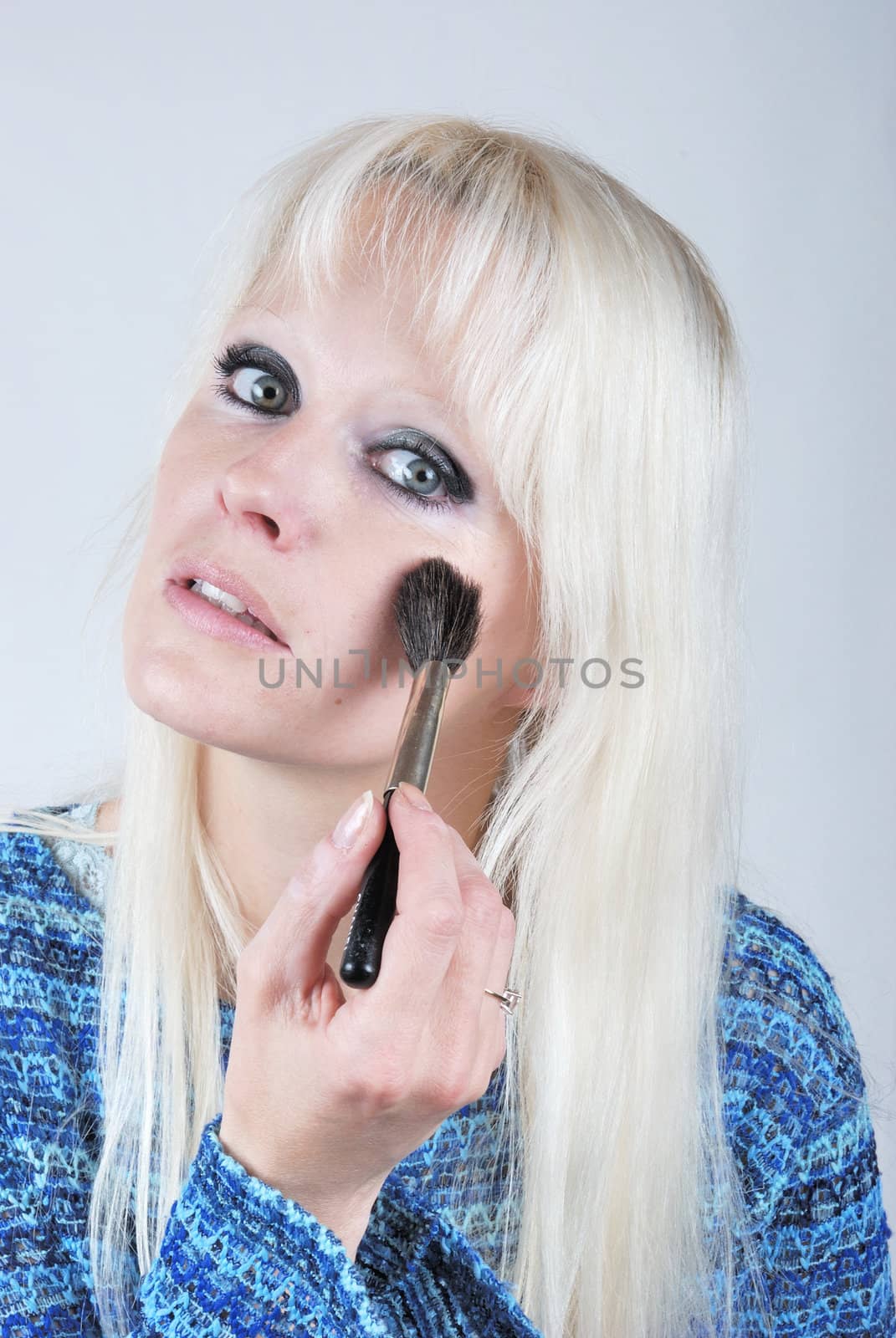  Woman applying makeup