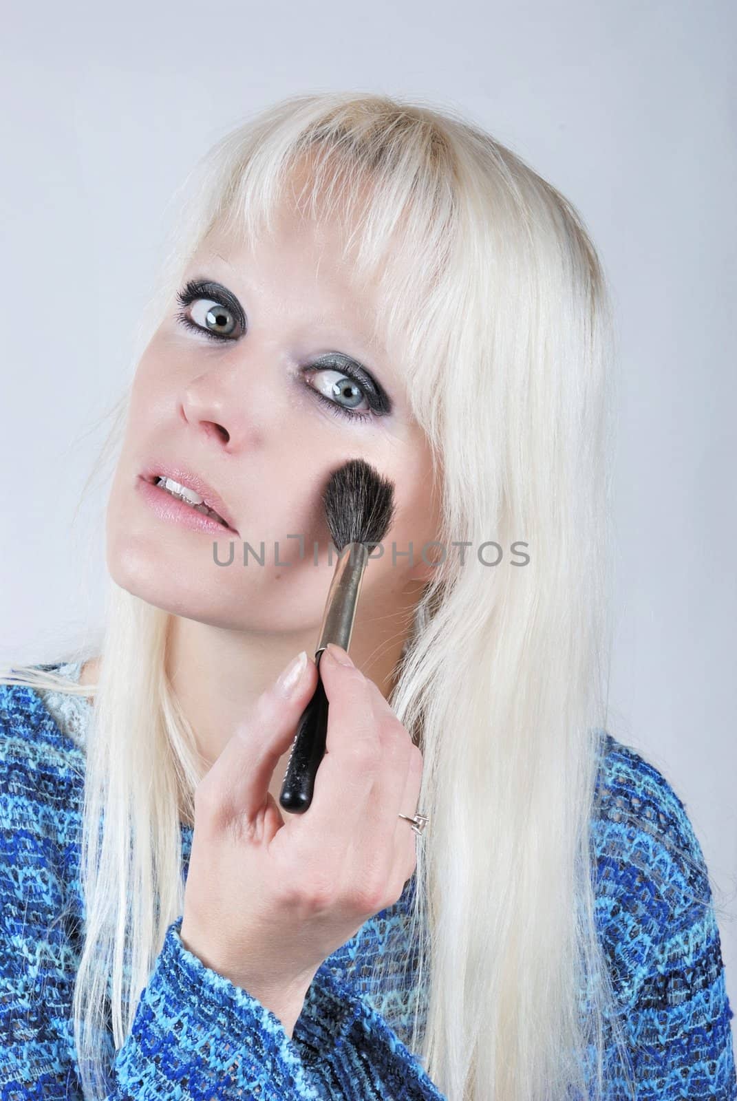  Woman applying makeup