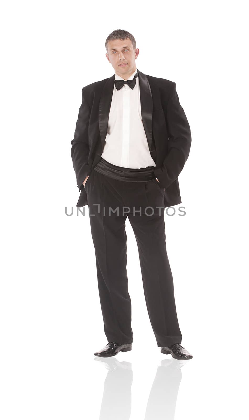 The elegant man in a classical tuxedo on a white background