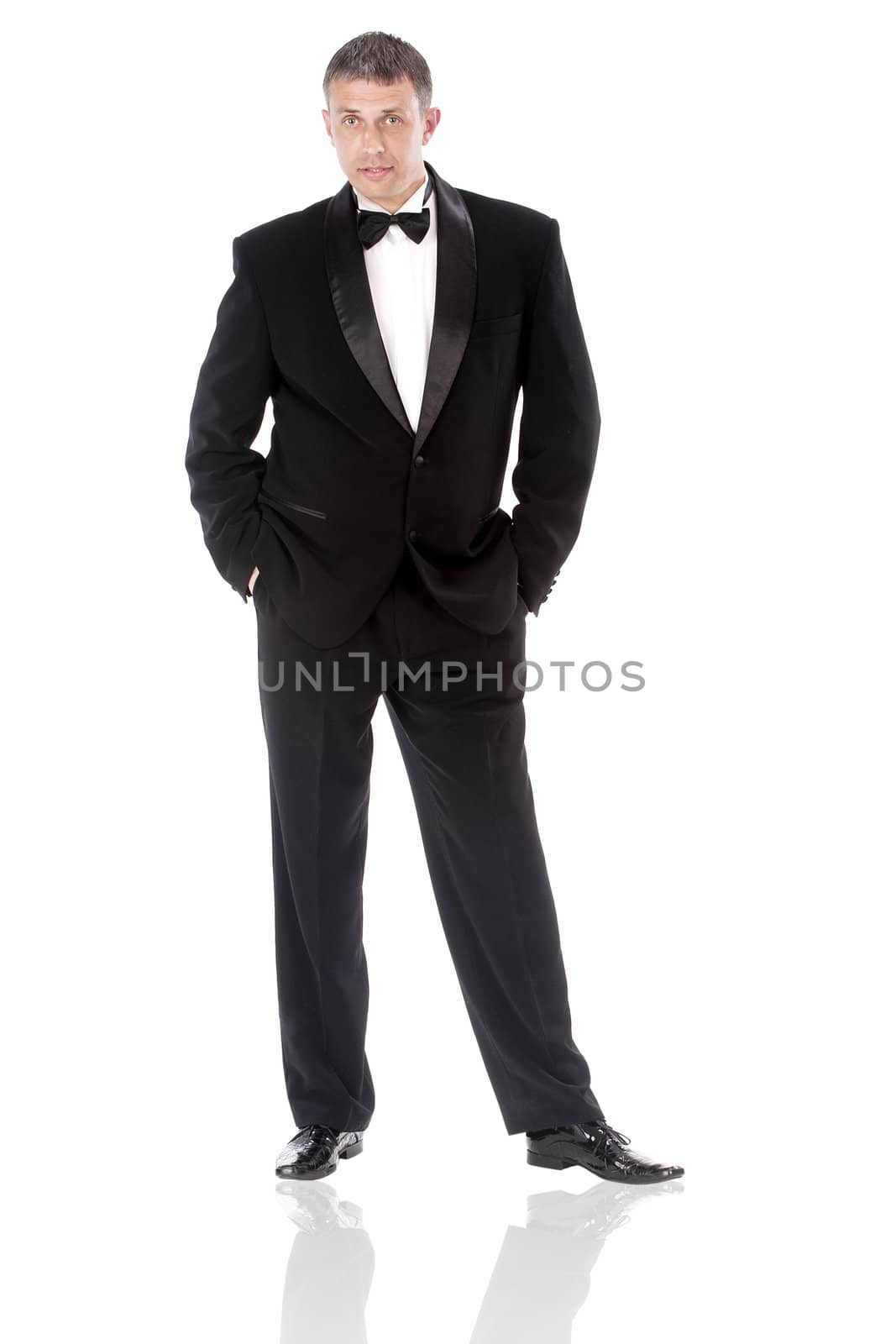 The elegant man in a classical tuxedo on a white background by sergey150770SV