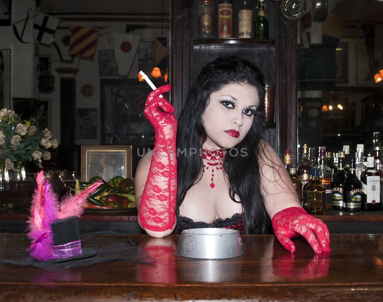 Portrait of a cabaret barmaid  behind a bar, smoking a cigarette