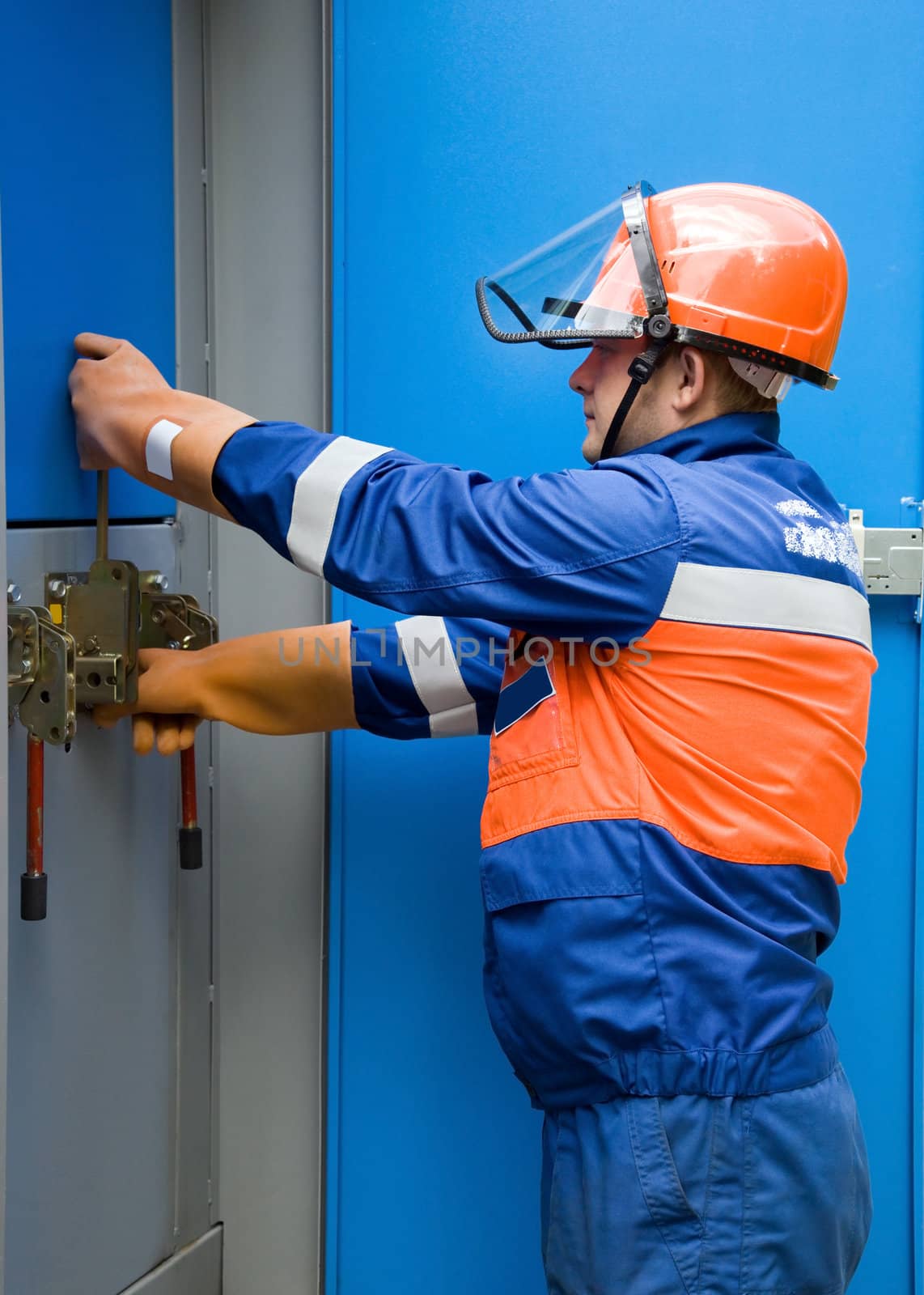 electrician working on a panel in the real world in the production of switches in a cell of the transformer substation