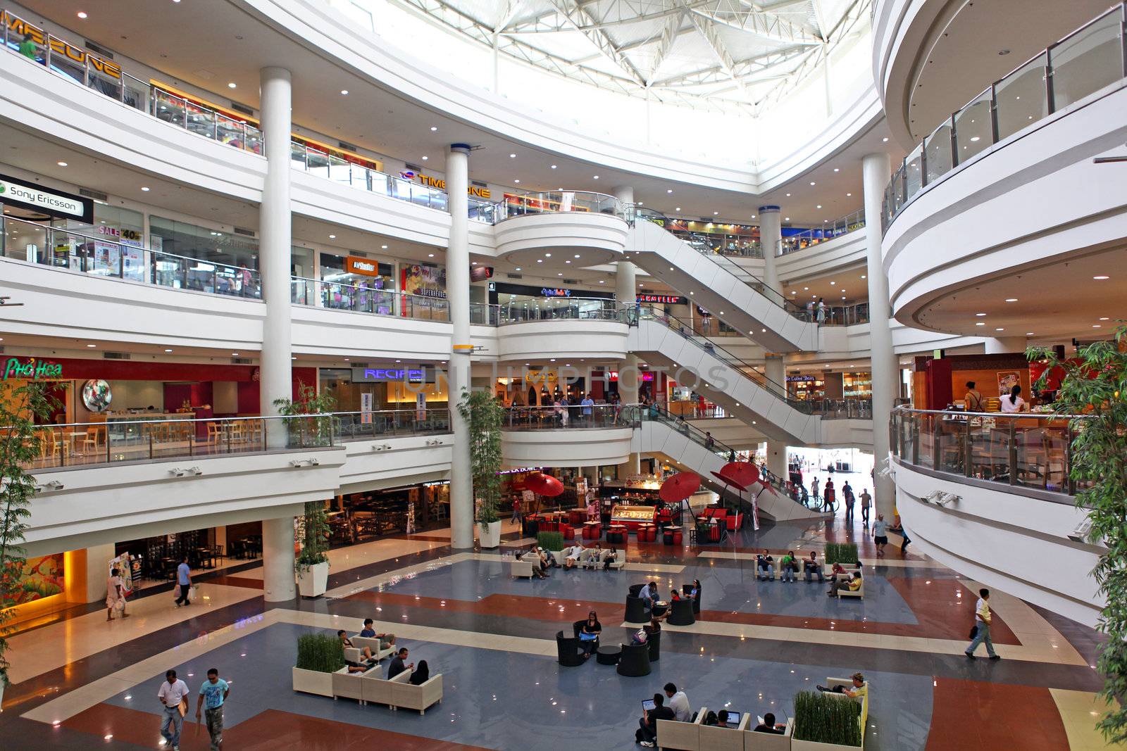 Interior of Robinson Shopping Mall in Manila, Philippine Islands showing the atrium and multiple balconies and walkways.