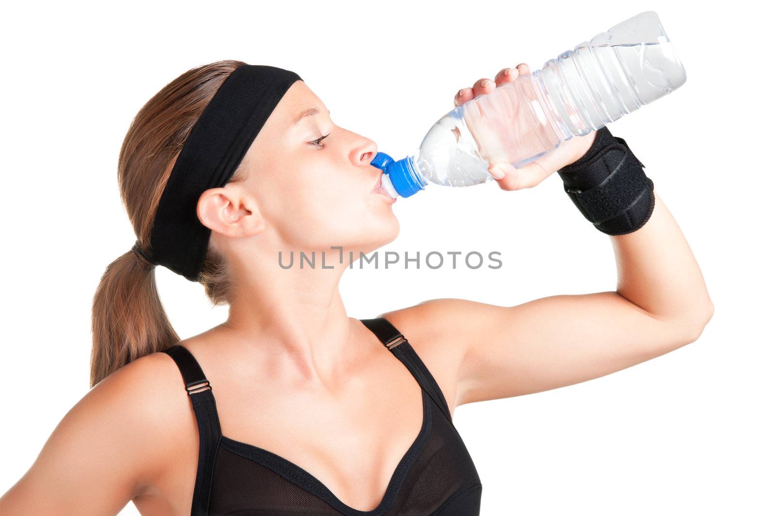 Woman drinking water from a plastic bottle, isolated in white