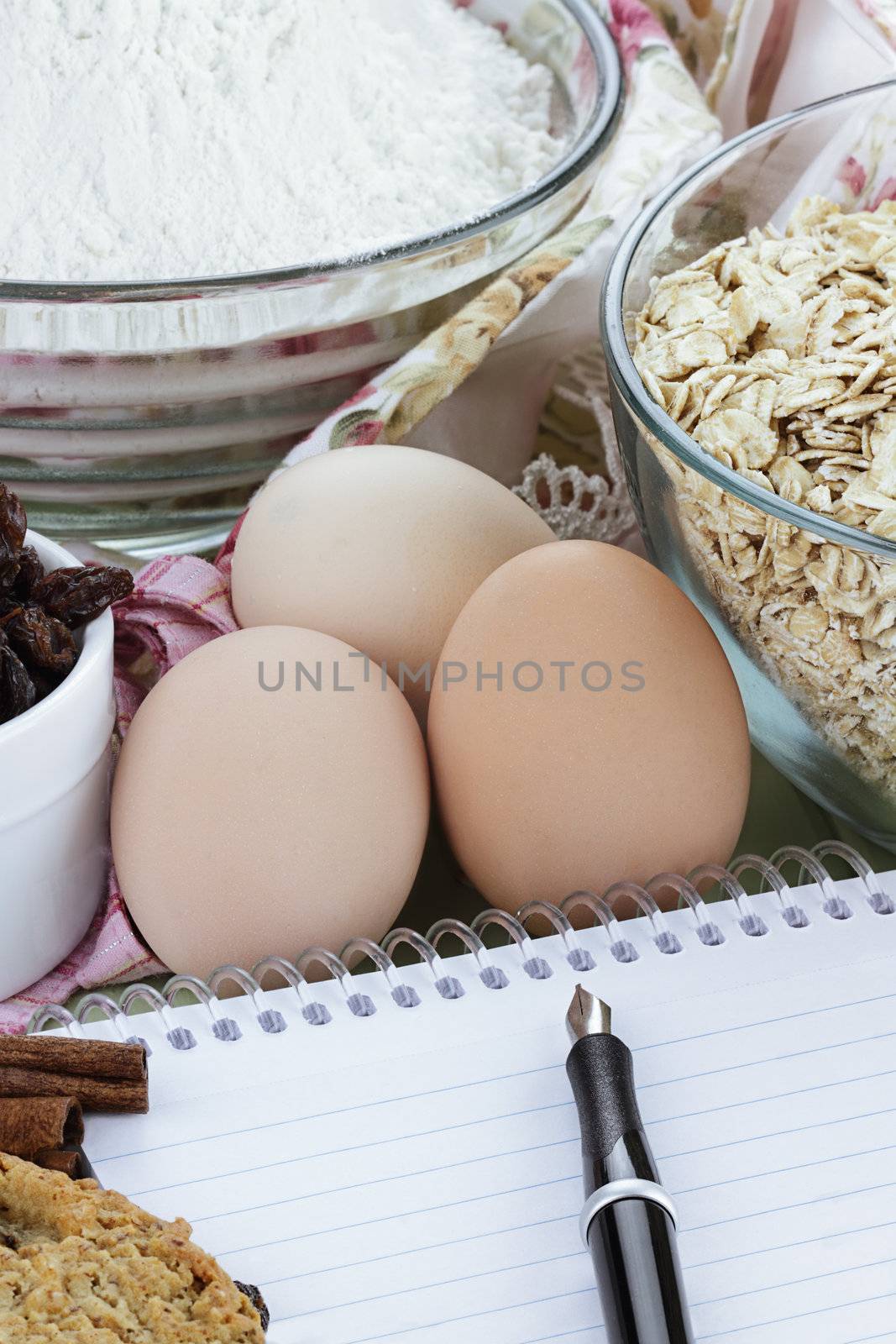 Fresh ingredients for oatmeal cookies with pen and paper. Shallow depth of field. 