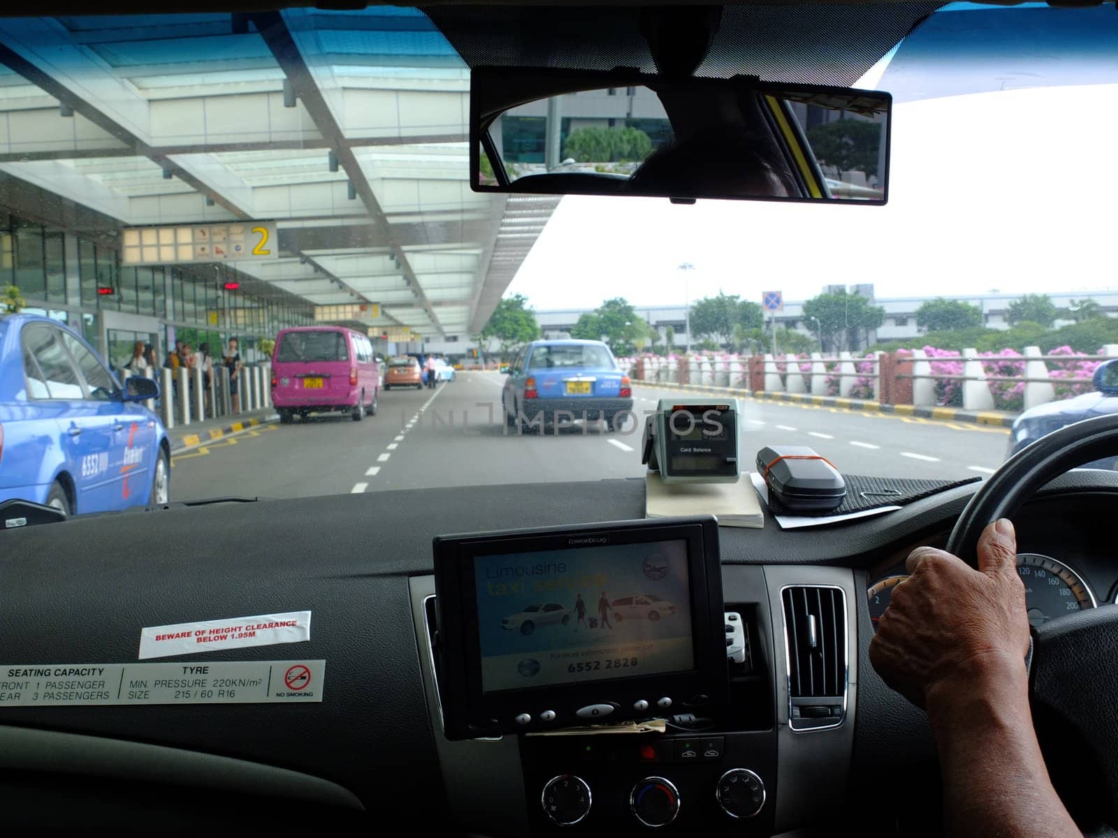 Taxi driver arriving at Changi international airport, Singapore.