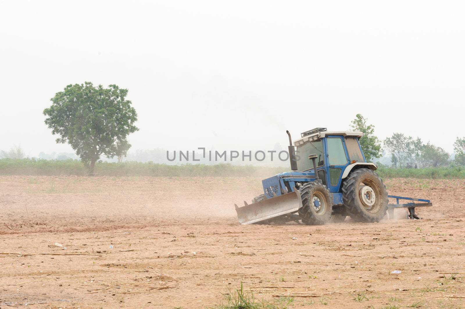 Small tractor in field by ngungfoto