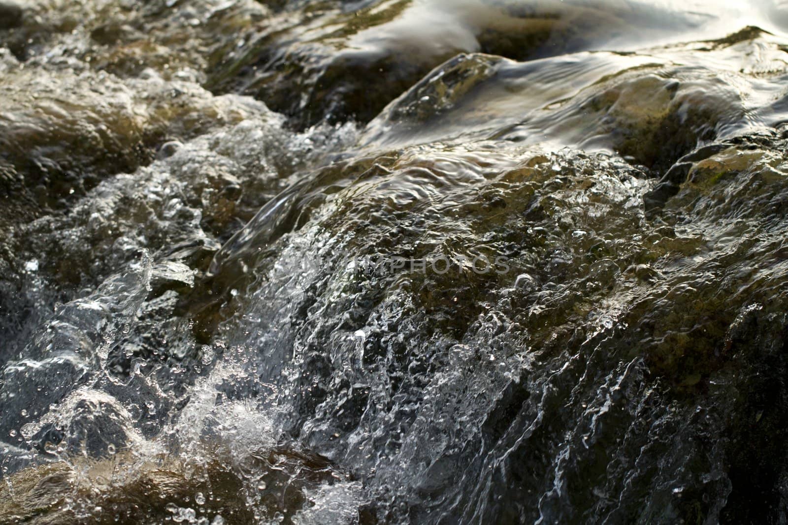 Close view of fast flowing fresh water on a river.
