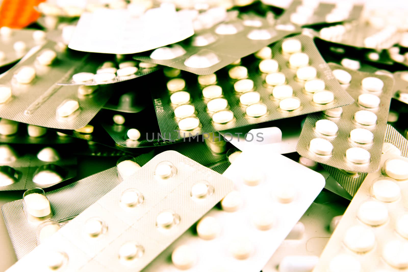Pills of many shapes and colors grouped together.