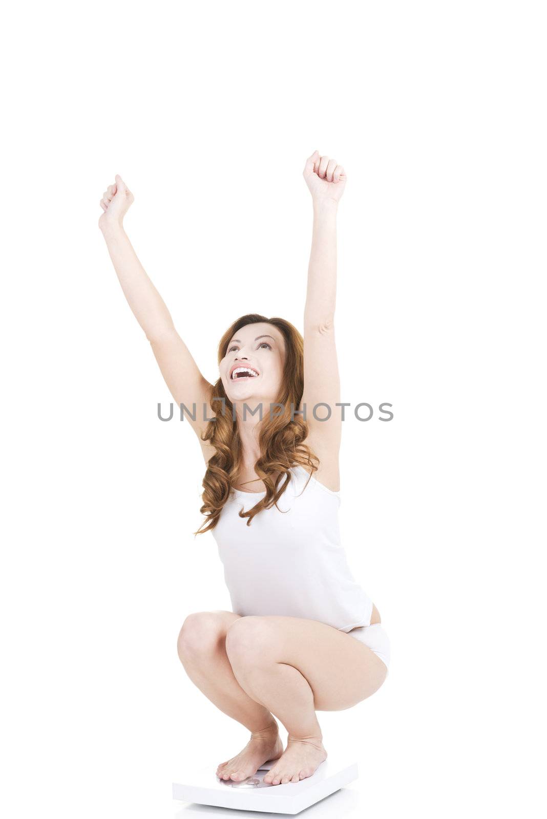 Happy woman on scale, isolated on white