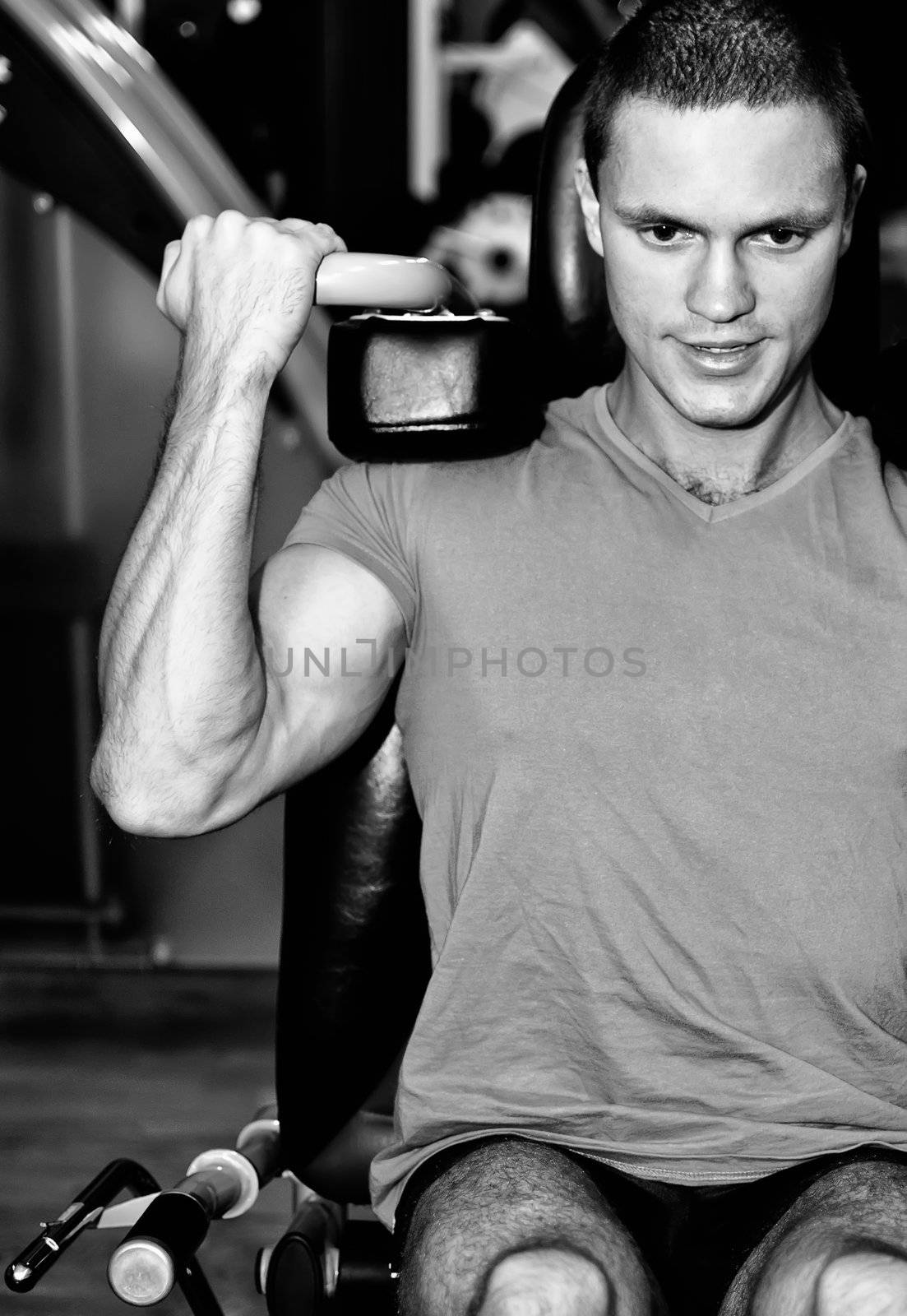 Man doing athlete exercise in fitness club