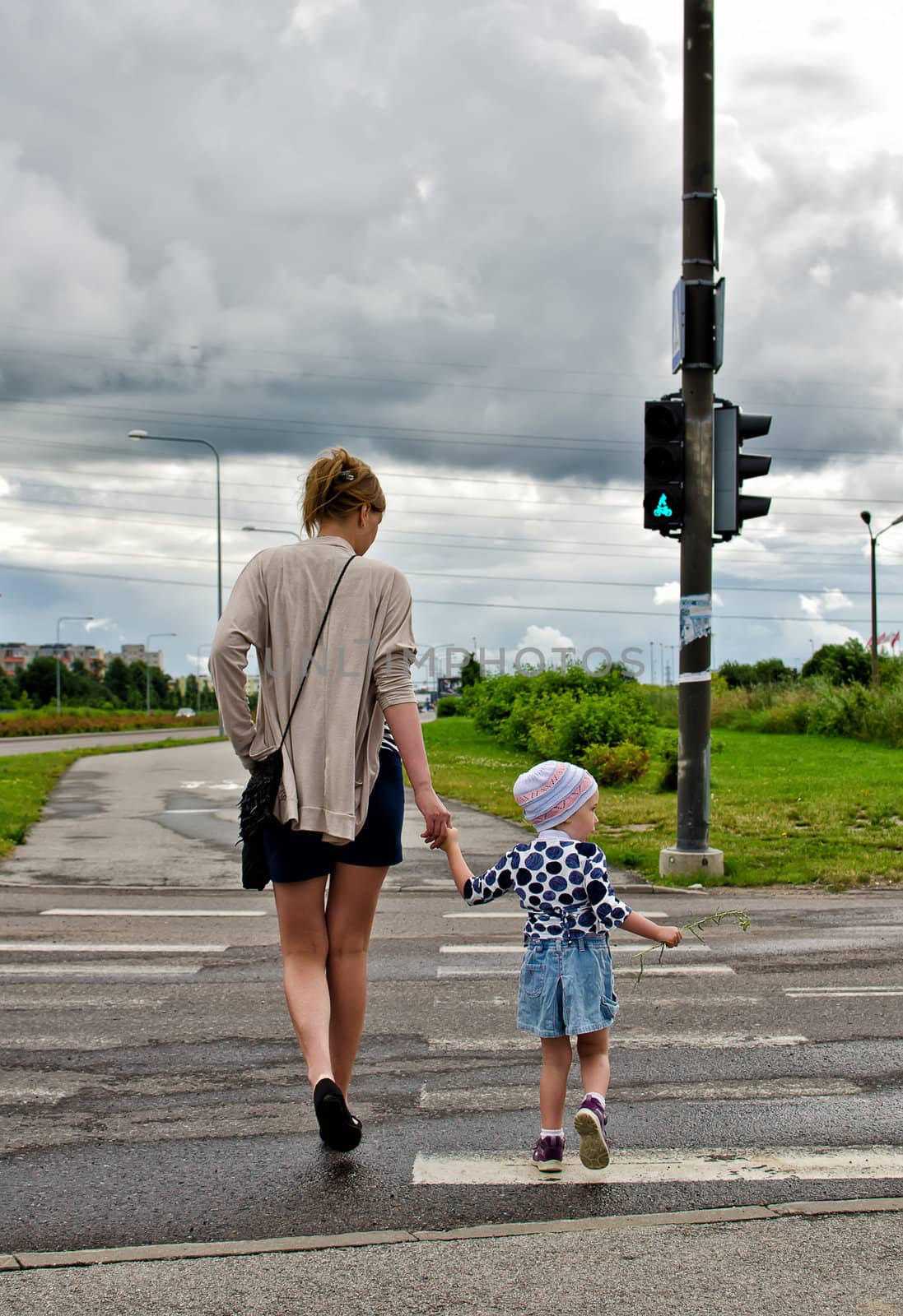 Mother and little daughter on zebra crossing