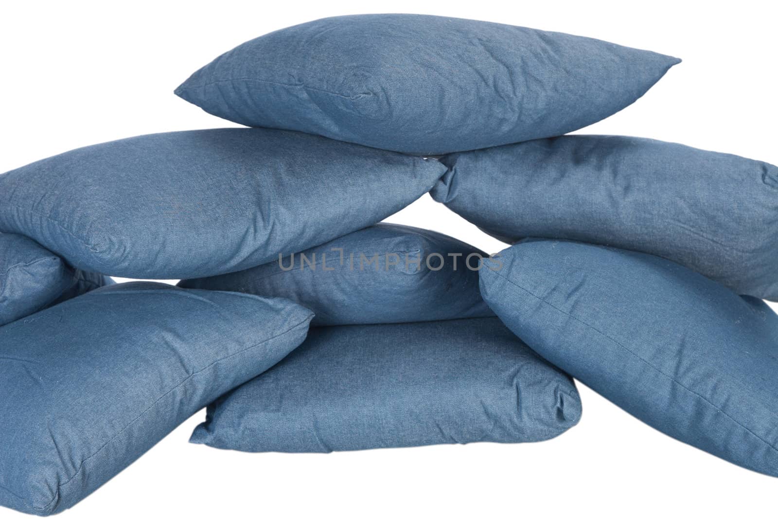 stack of blue denim pillows isolated on white