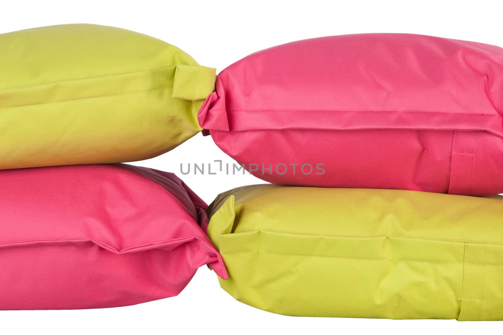 bright stack of pink and green pillows isolated on white