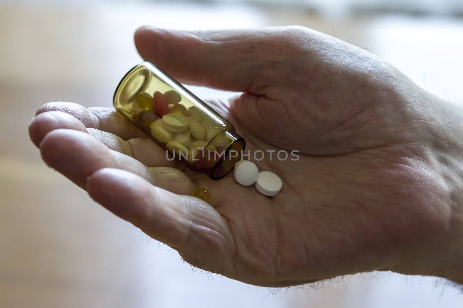 old man holding pills and he needs help