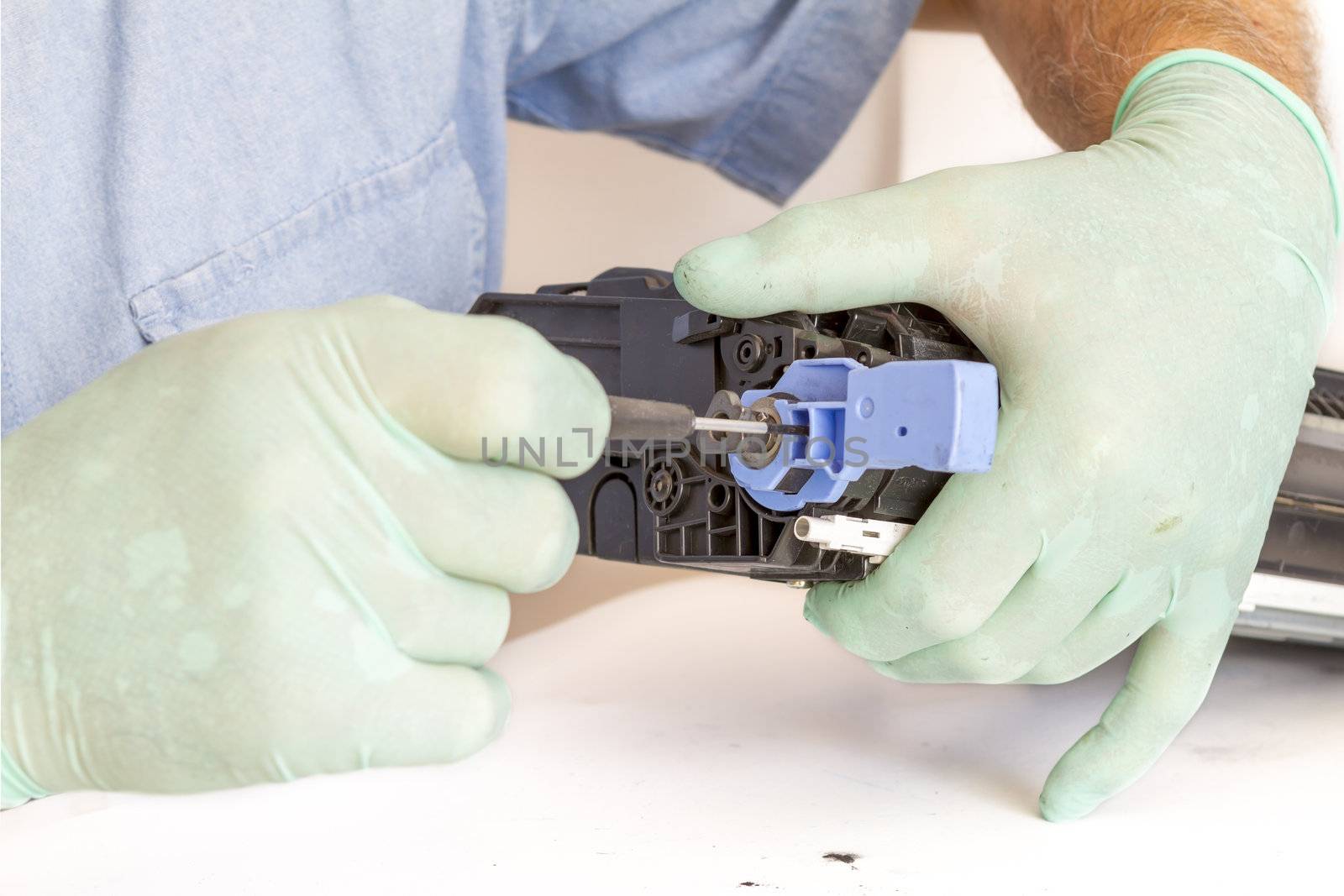 hands repairing toner cartridge by manaemedia
