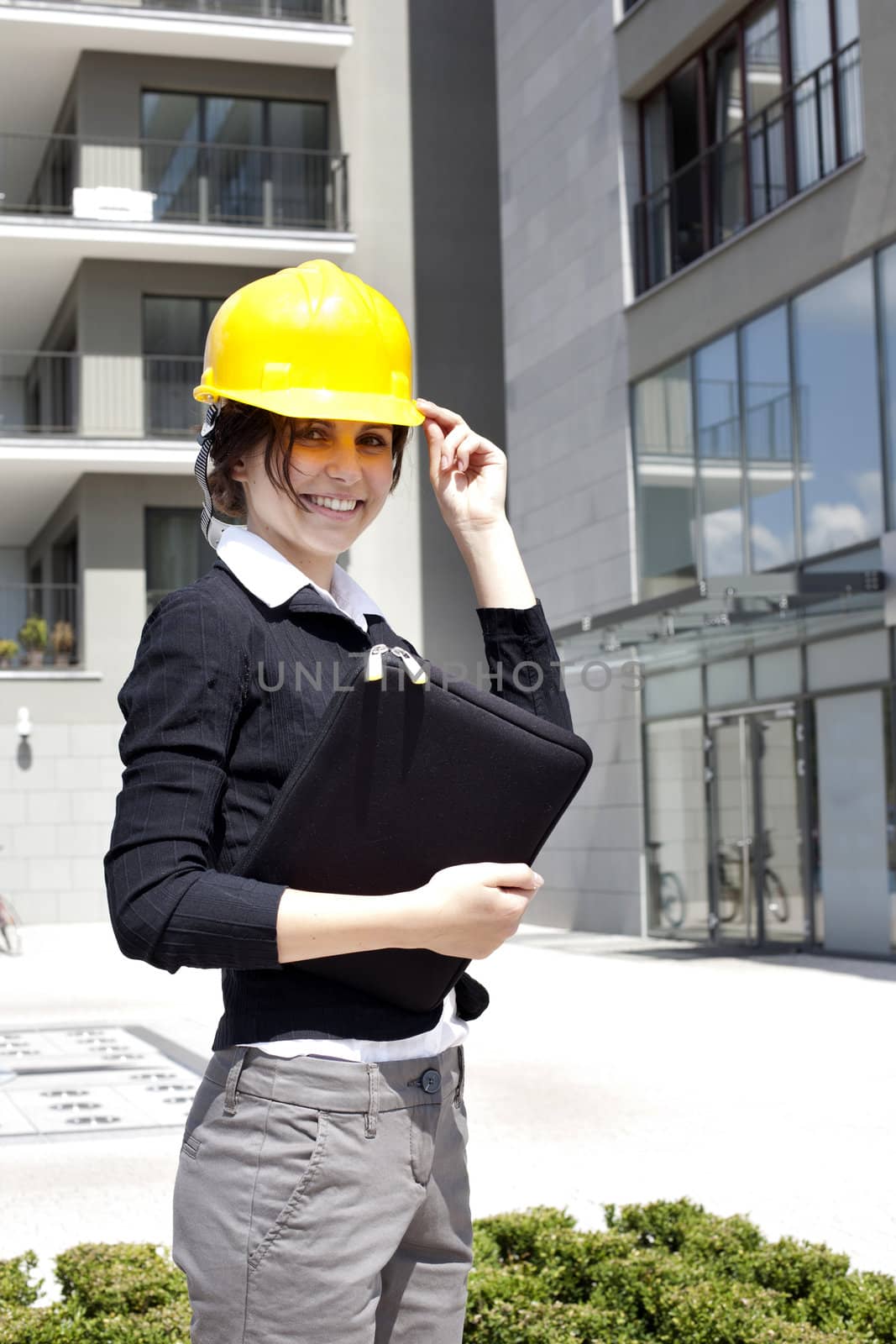 Female construction engineer and yellow helmet