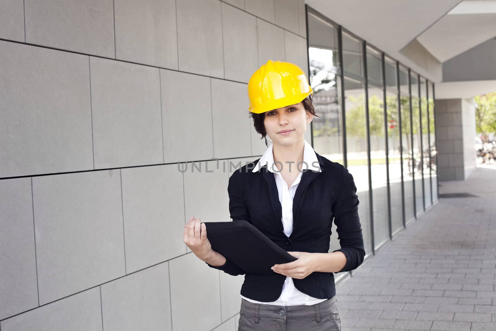 Female construction engineer and yellow helmet