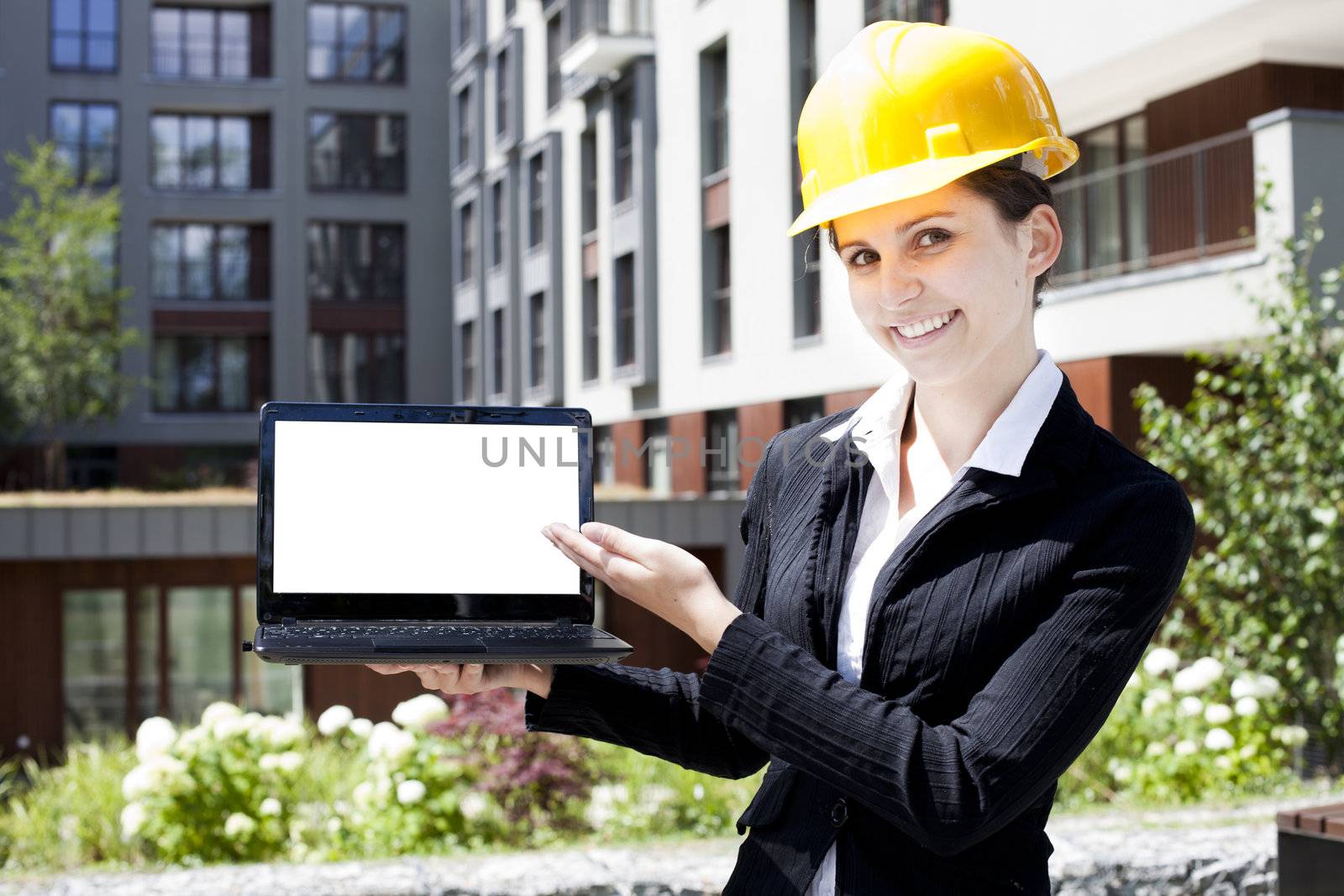 Female construction engineer show something on laptop