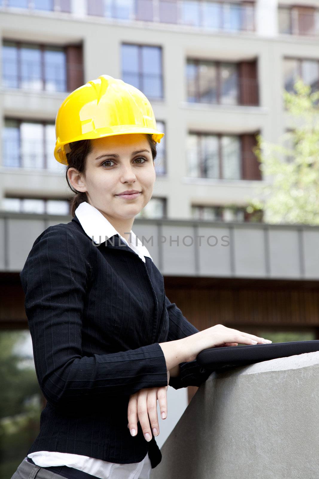 Female construction engineer and yellow helmet