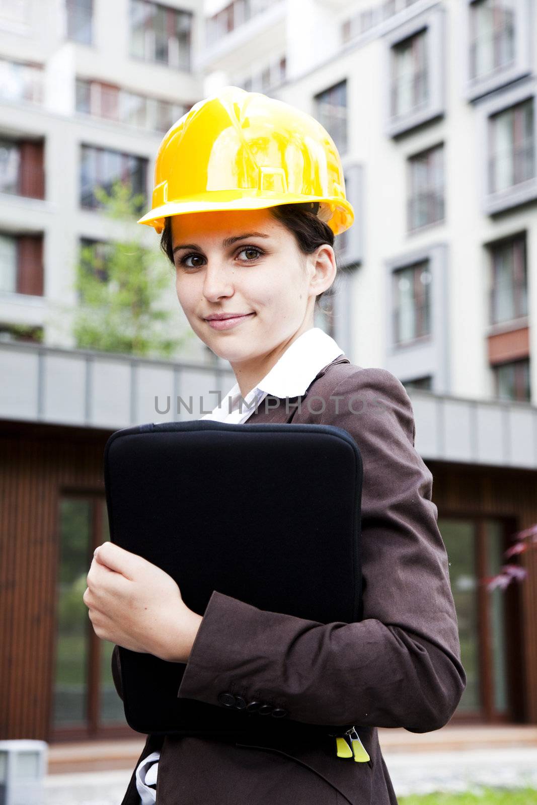 Female construction engineer and yellow helmet