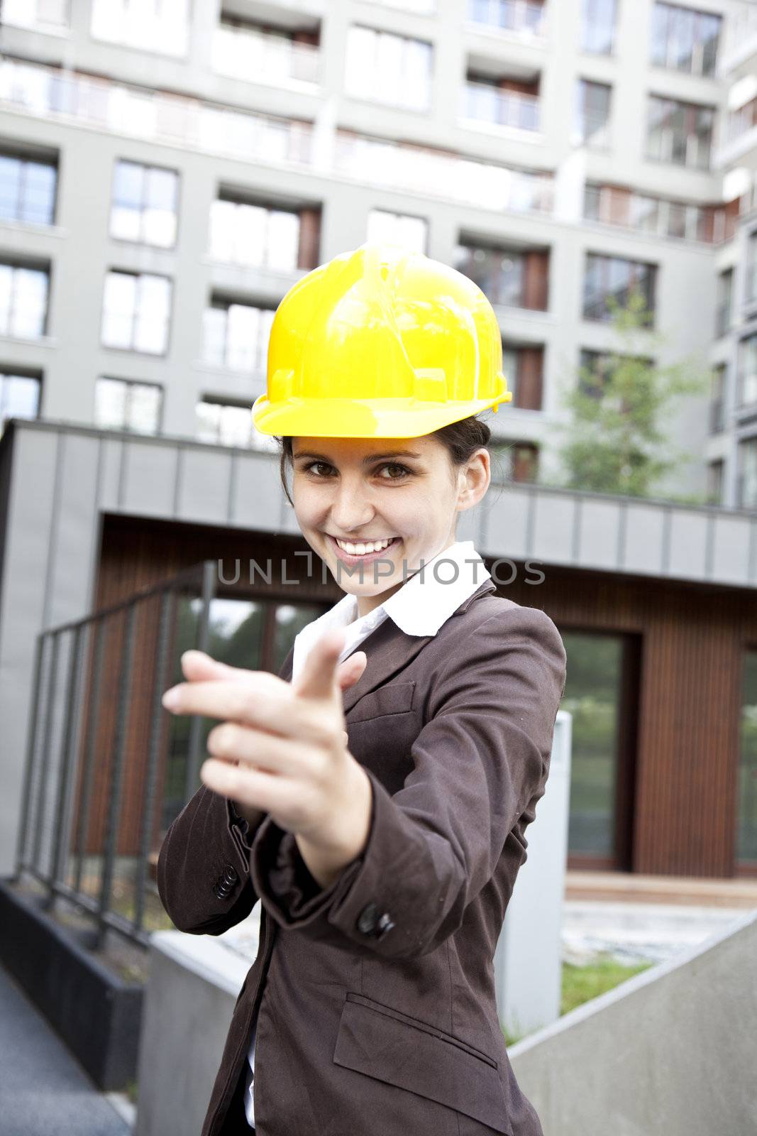 Young female construction engineer with phone