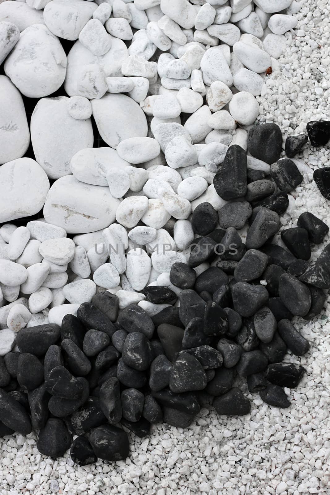 White and black round pebble stones and gravel background