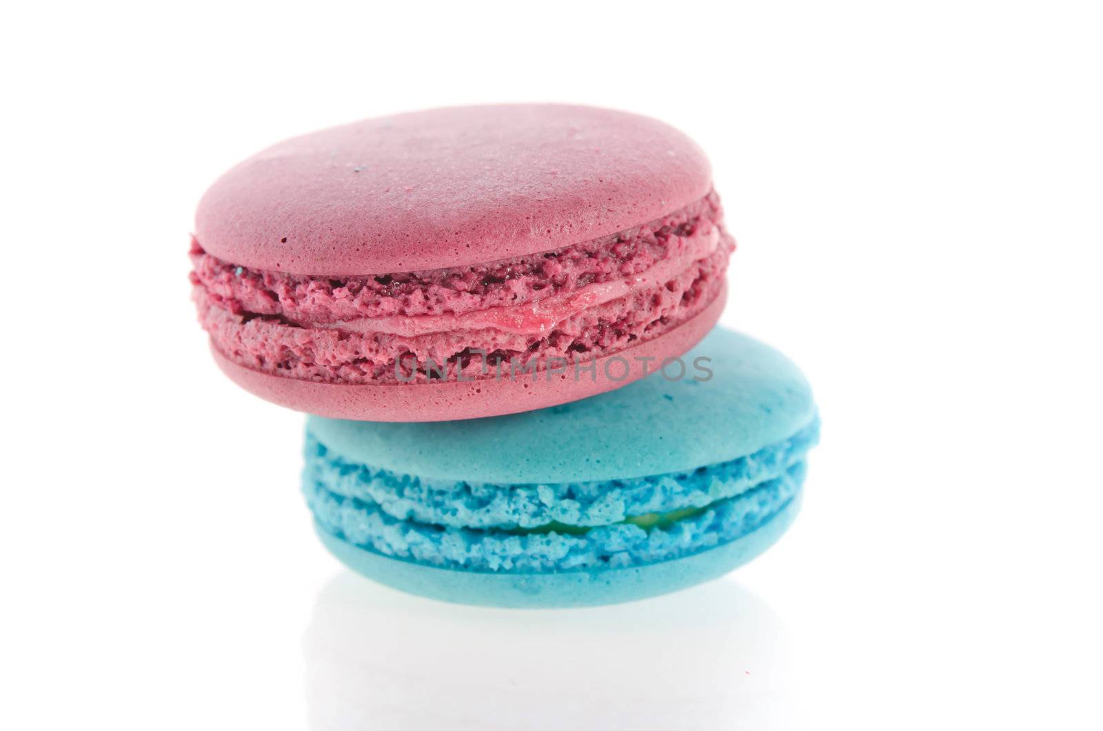close up French macaroons in turquoise and violet on white