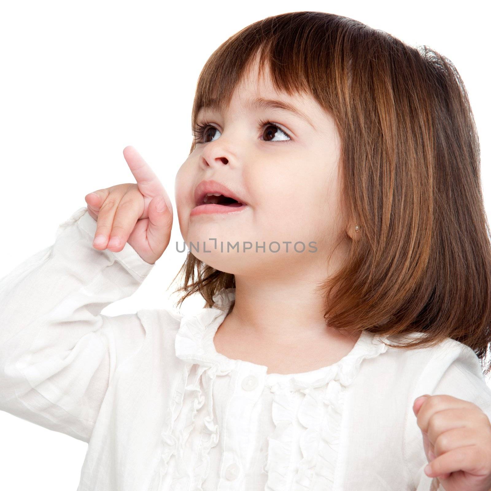 Portrait of cute little girl pointing with finger. Isolated on white background.