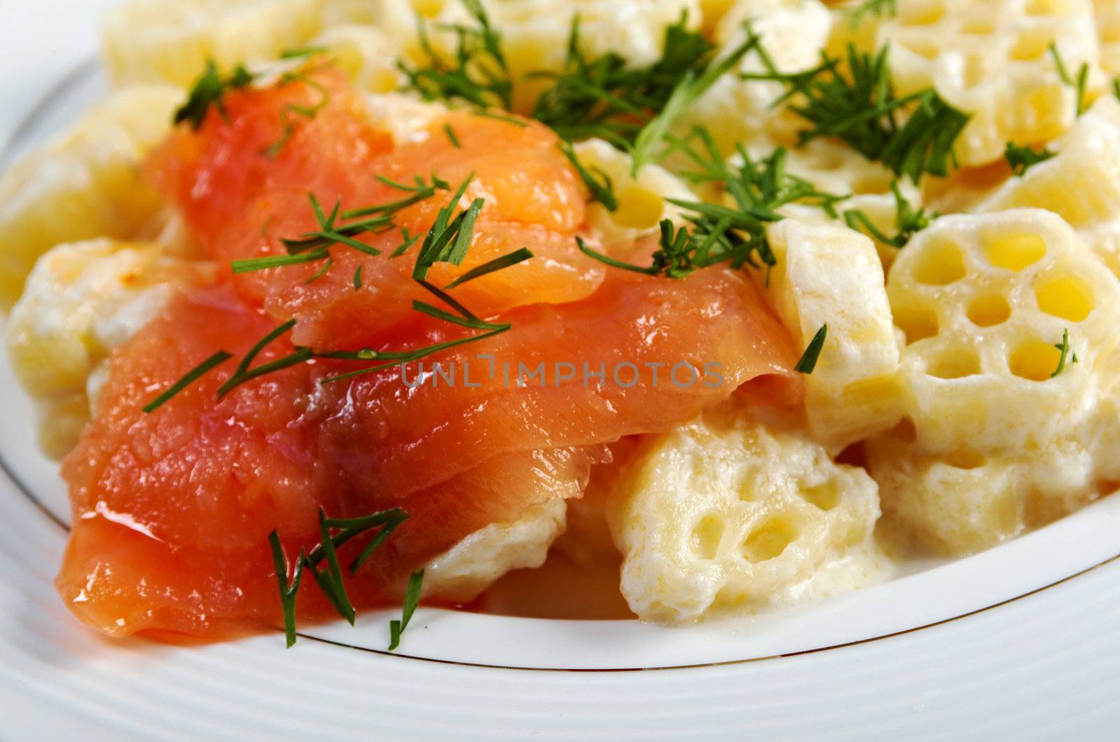 ruote pasta with cream sauce and salmon.closeup