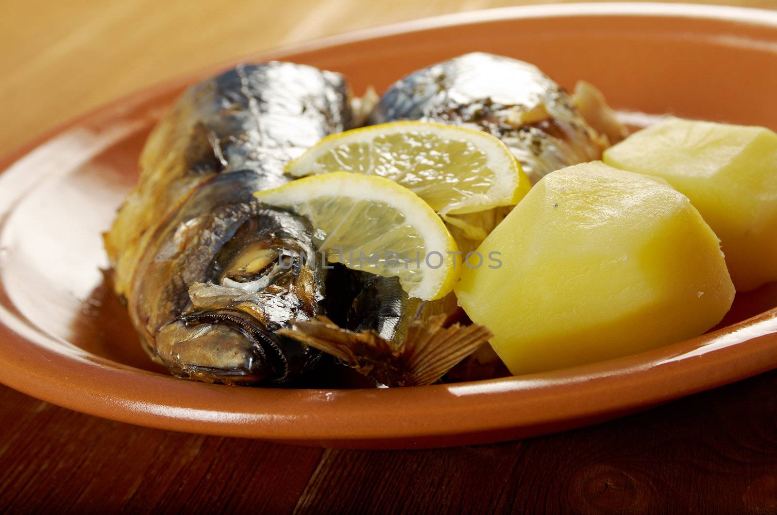 Mackerel on a grill. Fish prepared  with vegetables